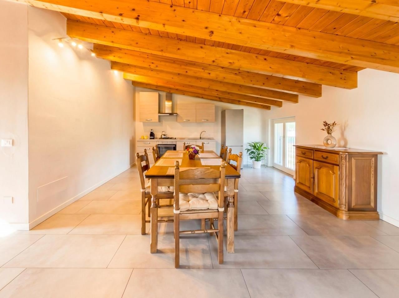 Fitted kitchen and dining area under wooden beams