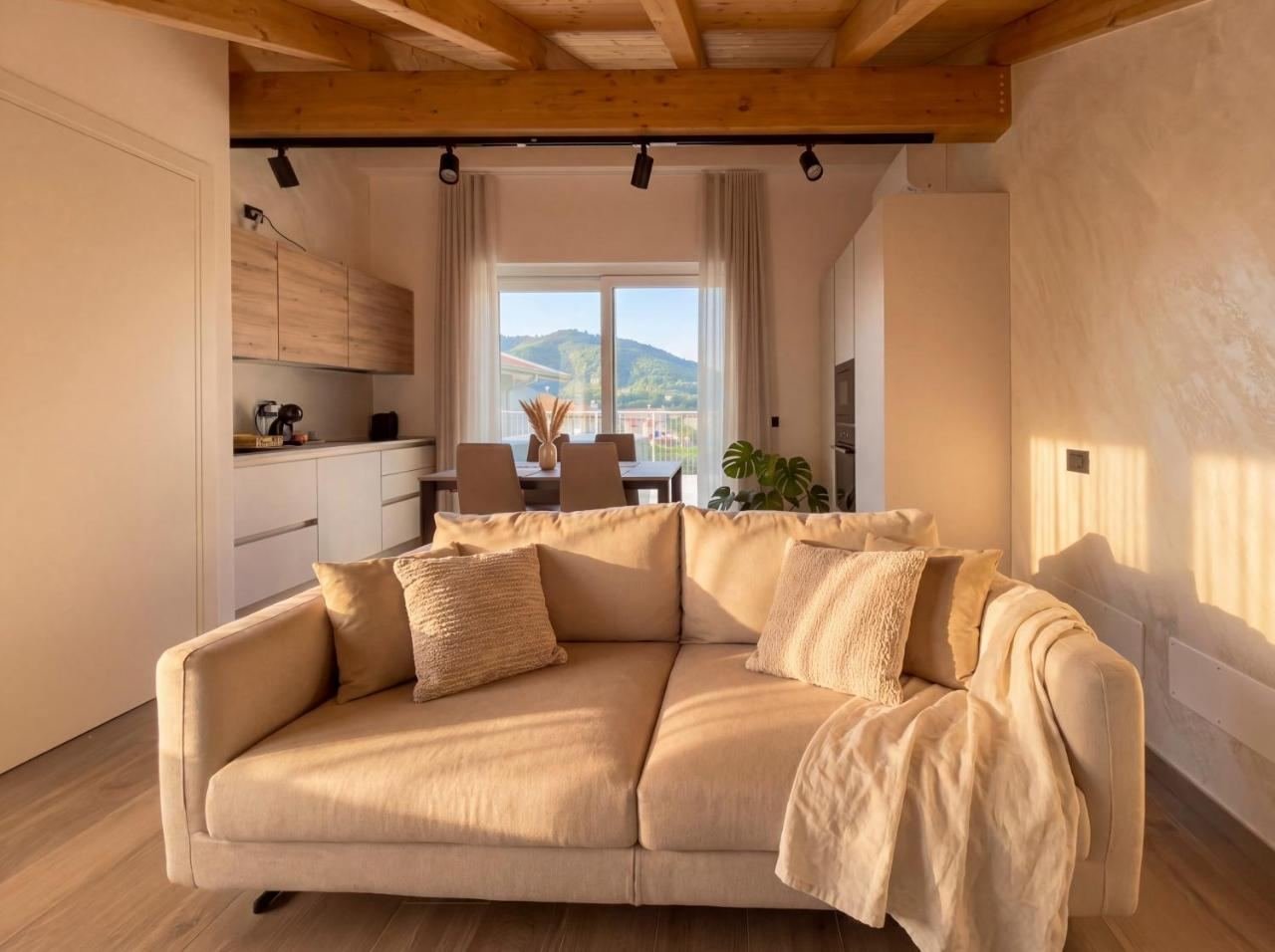 Dining area of the penthouse with a table and exposed beams