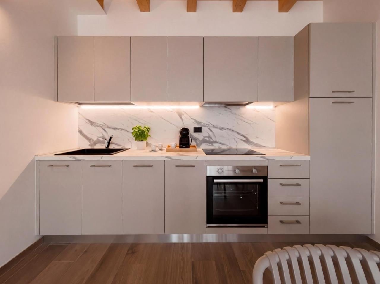 Fitted kitchen of the Premier Apartment with oven and hob