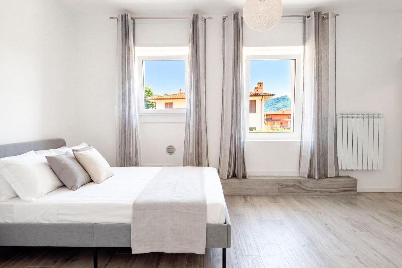 Double bedroom of the Deluxe apartment with windows overlooking the town