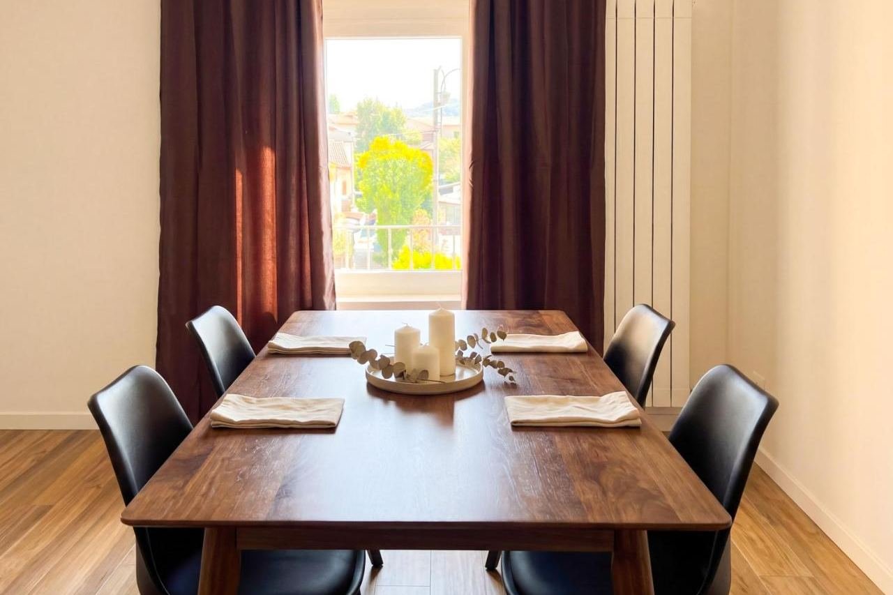 Dining area of the Superior apartment with a laid table by the window