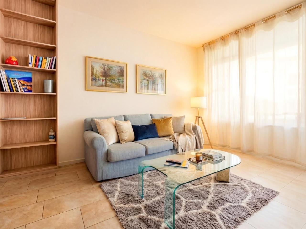 Sitzecke mit hellblauem Sofa, Eckregal und Glastisch