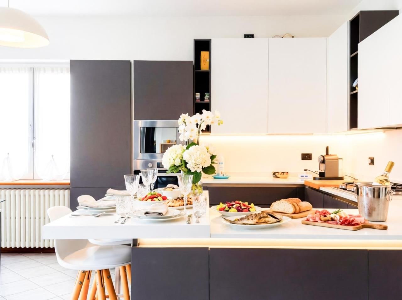 Open-plan fully equipped kitchen with an island and dining area