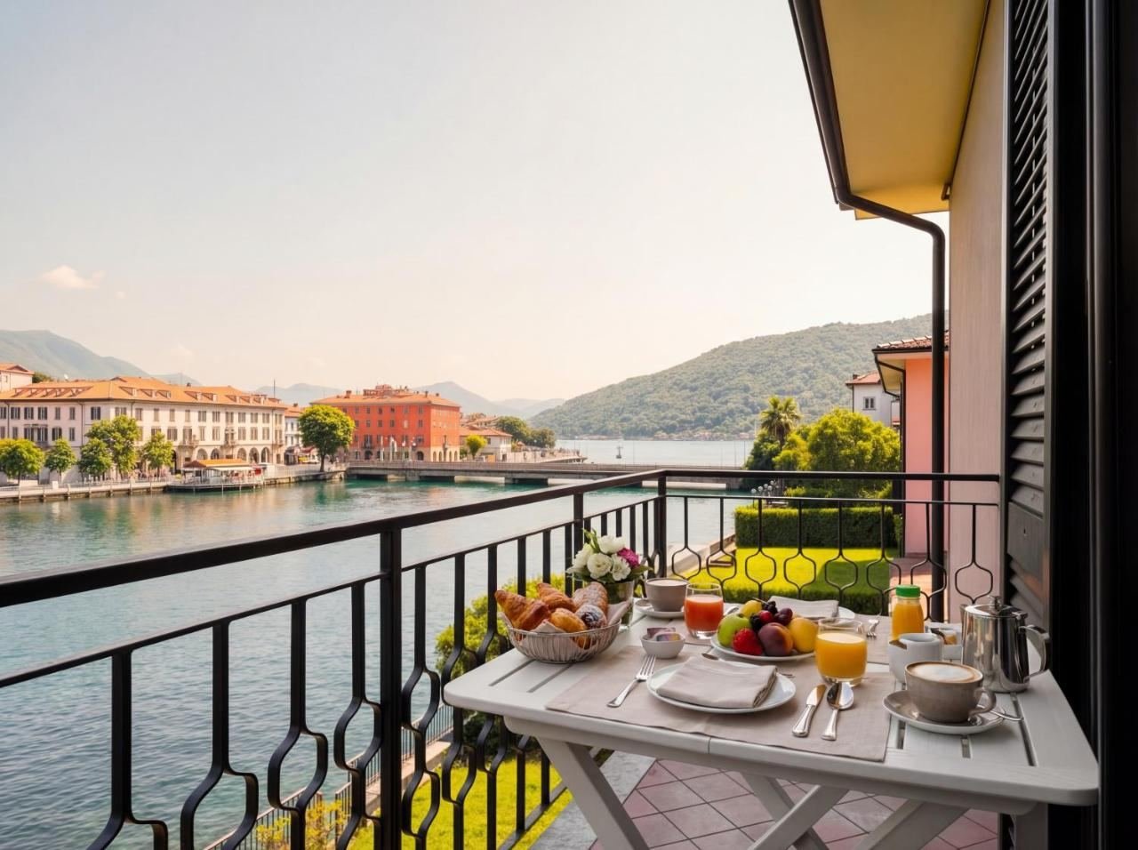 Private terrace of the apartment with a laid table and a panoramic view of Lake Iseo in Paratico