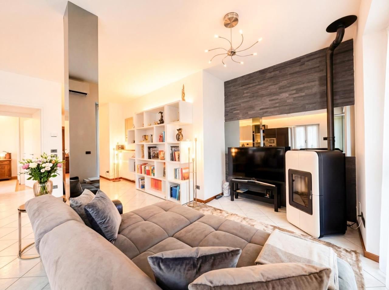 Spacious, bright living room with a sofa and bookshelves