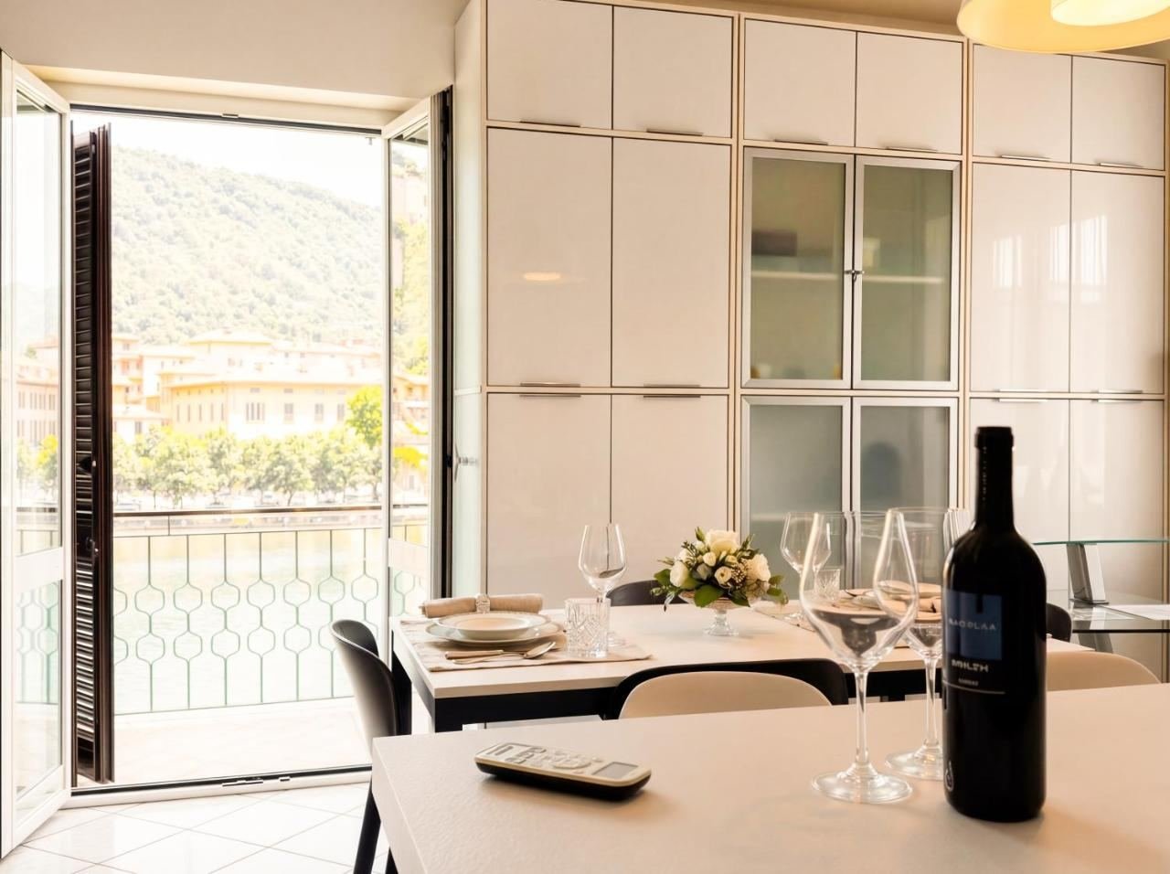 Dining area with French doors opening onto the balcony and lake view