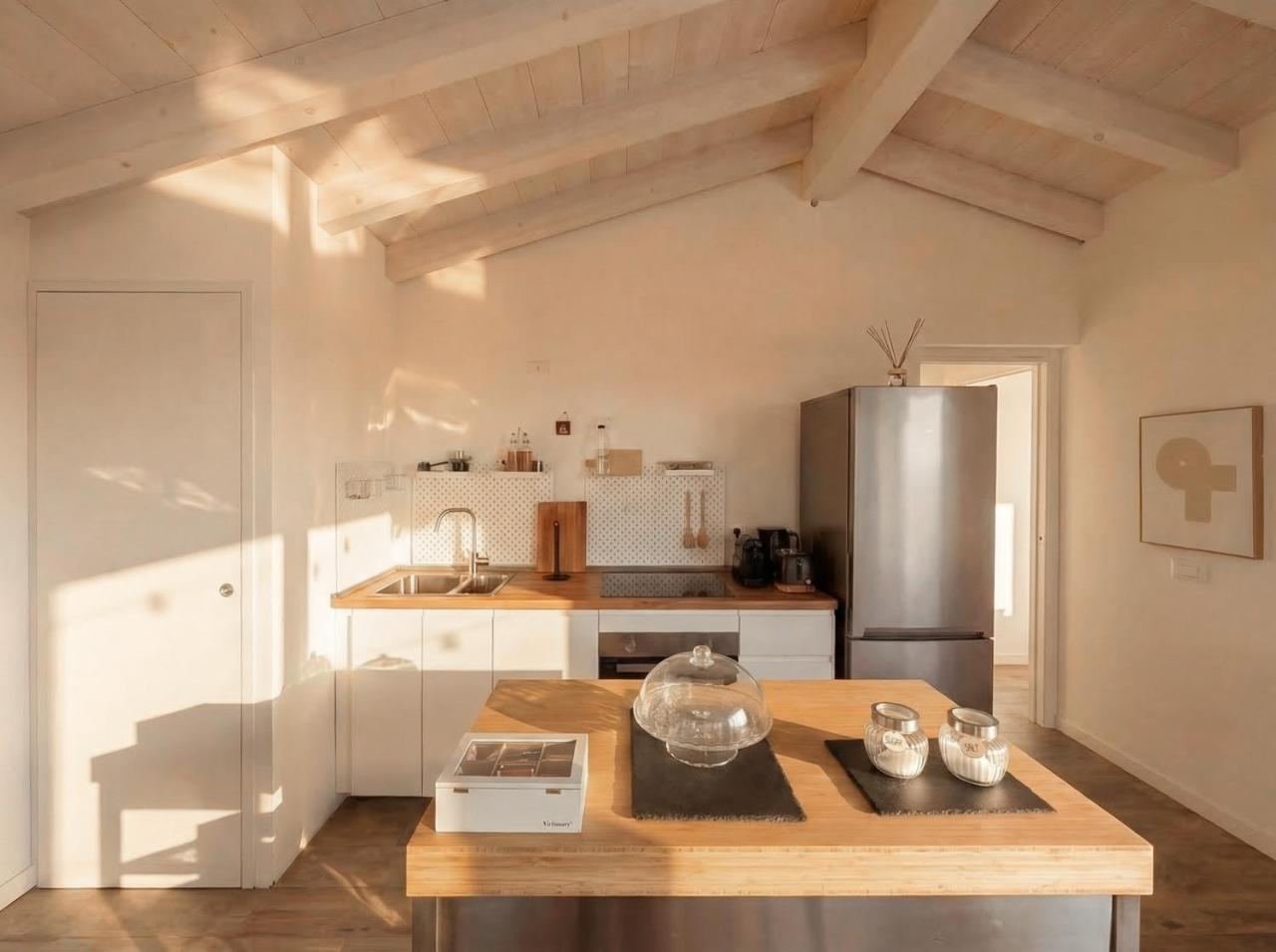 Full kitchen with an island, hob, oven and dishwasher, with a skylight