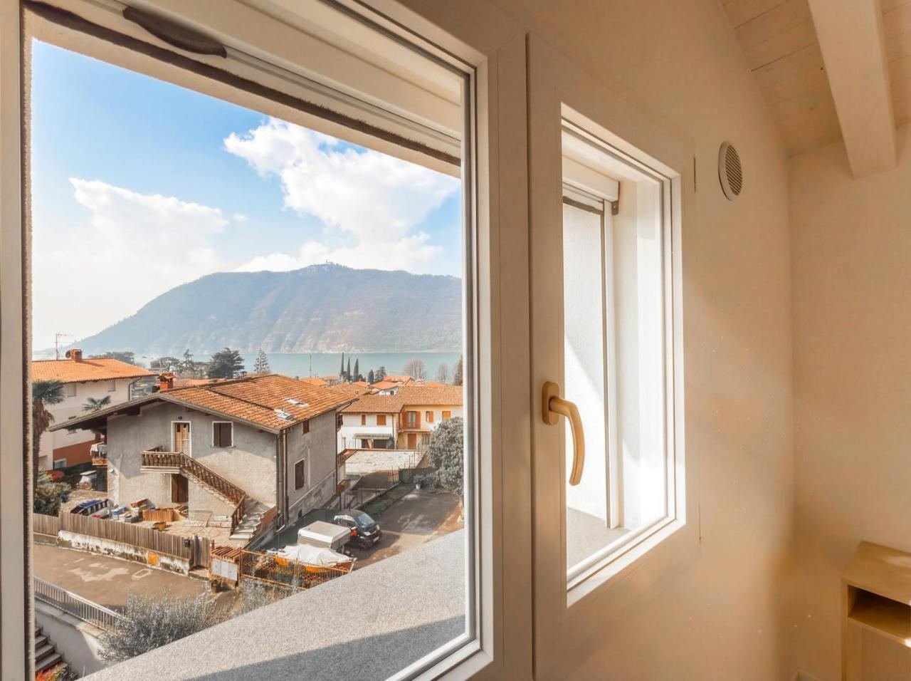 View over Lake Iseo and the village of Sale Marasino from a window of the penthouse